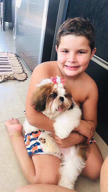 The kid, Arthur, holding Luna, the shih-tzu. 