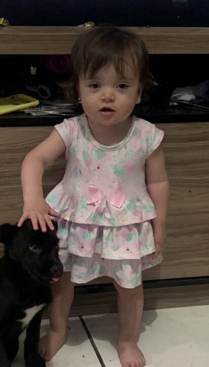 Ysabella and the little dog together at home. 