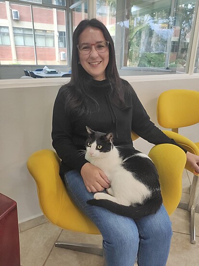 Tuti sitting in the lap of Cris Jaqueline, one of the radio announcers.