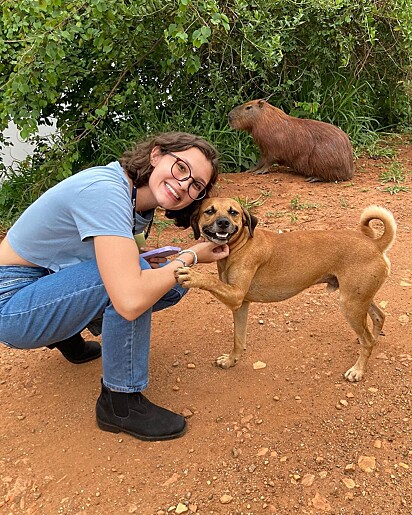 The caramel dog smiling in the photo.