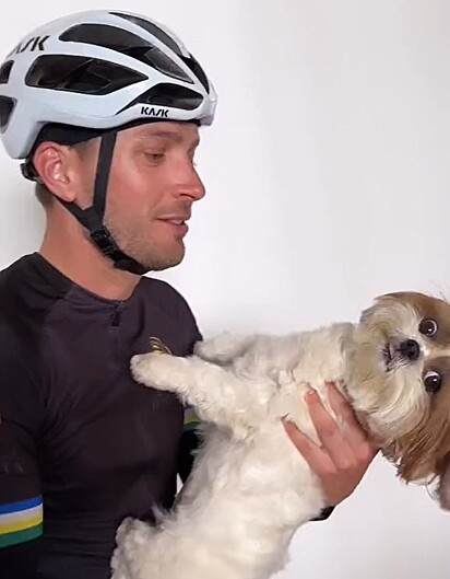 The Shih Tzu pushing Gabriel away with her paws.